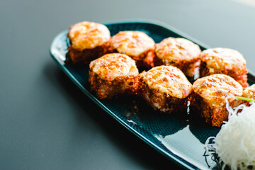 Maki and nigiri sushi variety with salmon, shrimp, avocado and tuna at a sushi restaurant