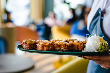 Maki and nigiri sushi variety with salmon, shrimp, avocado and tuna at a sushi restaurant