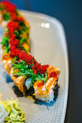 Maki and nigiri sushi variety with salmon, shrimp, avocado and tuna at a sushi restaurant