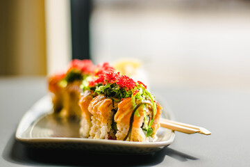 Maki and nigiri sushi variety with salmon, shrimp, avocado and tuna at a sushi restaurant