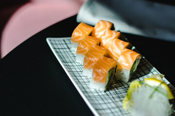 Maki and nigiri sushi variety with salmon, shrimp, avocado and tuna at a sushi restaurant