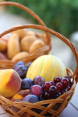 Two baskets full of fresh fruit and vegetable in a garden. Selective focus.