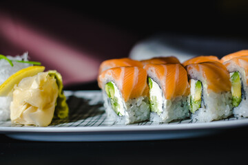 Maki and nigiri sushi variety with salmon, shrimp, avocado and tuna at a sushi restaurant