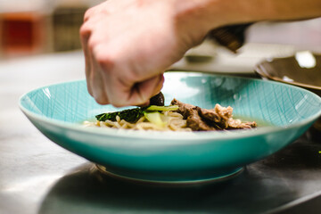Beef ramen soup with poached egg and vegetables at a restaurant