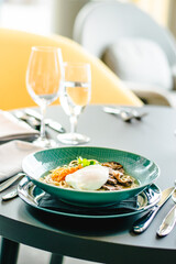 Beef ramen soup with poached egg and vegetables at a restaurant