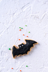 Top view of Halloween festive decorated icing sugar cookies on white background.