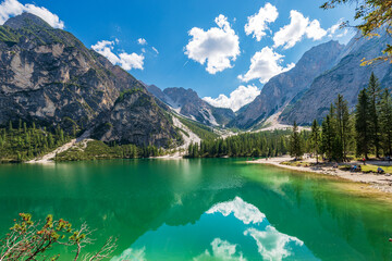 Naklejka na ściany i meble Small beautiful lake in Italian Alps. Pragser Wildsee or Lago di Braies and mountain range of Croda del Becco or Seekofel and Sasso del Signore. Dolomites, Trentino-Alto Adige, Italy, Europe.