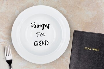 Fasting and prayer. Christian biblical concept, empty plate with Holy Bible.