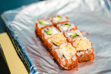 Sushi chef making maki and sashimi sushi at a sushi restaurant