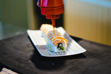 Sushi chef making maki and sashimi sushi at a sushi restaurant