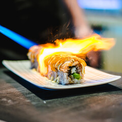Sushi chef making maki and sashimi sushi at a sushi restaurant © Mzals