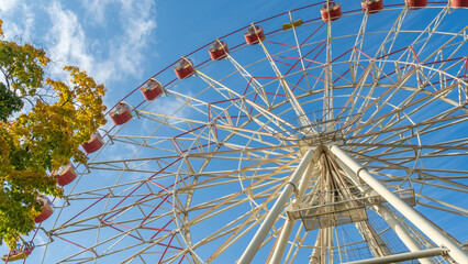 Ferris Wheel With Cabins.carousel against blue sky in a amusement park.
