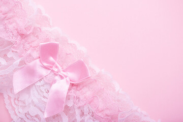 Beautiful gentle pink background made of lace female underwear with room for text. erotic underwear