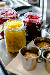 Pike cutlet with pumpkin sauce and fermented cabbage in different colors at a restaurant