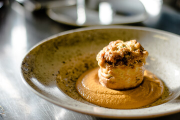 Pike cutlet with pumpkin sauce and fermented cabbage in different colors at a restaurant