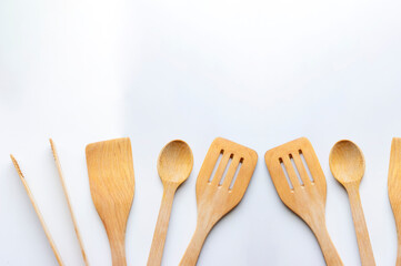 Diferentes utensilios de cocina, de madera, sobre fondo de color blanco