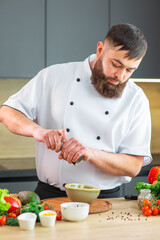 The man prepares food at home. Cooking healthy and tasty food.