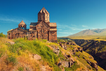 Fototapeta na wymiar Hovhannavank monastery and church on the edge of a scenic Kasakh gorge and canyon. Tourist and religious destinations and attractions in Armenia