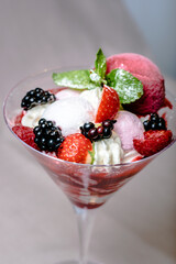 Ice cream serving in a glassware with different berries