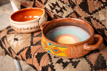 Pottery items are offered for sale with national and folklore patterns in oriental style