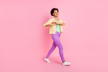 Full length body size view of attractive cheerful girl going showing heart sign isolated over pink pastel color background