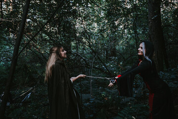 Fototapeta premium girl in a historical dress in a coniferous forest