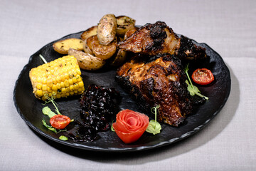 Fried ribs witch sauce and vegetables prepared at a restaurant