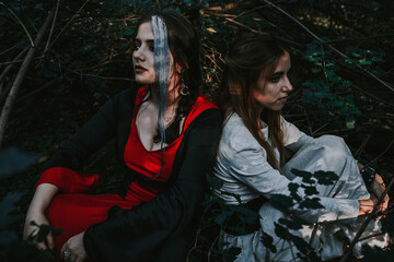 girl in a historical dress in a coniferous forest