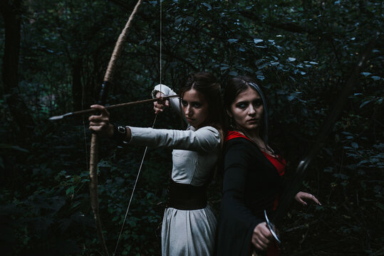 girl in a historical dress in a coniferous forest