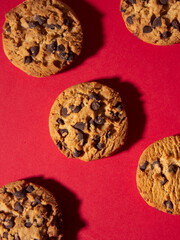 top view of homemade chocolate chip cookies on a red Christmas background