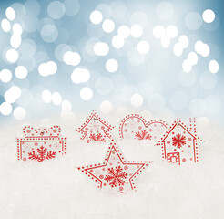 Christmas background with wooden figurines with glare and light spots, artificial snow