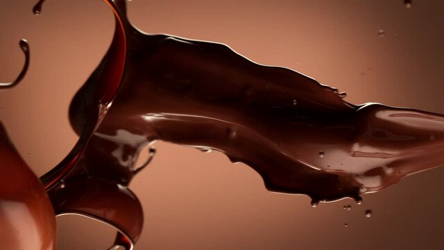 Super slow motion of rotating dark hot chocolate splashes. Filmed on high speed cinema camera, 1000fps.