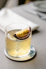 Old fashioned cocktail with a twist with passion fruit