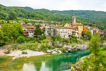Fototapeta na wymiar Beautiful, colorful, picturesque small town of Kanal, Slovenia with the clear turquoise Soca River carving the white rocks.