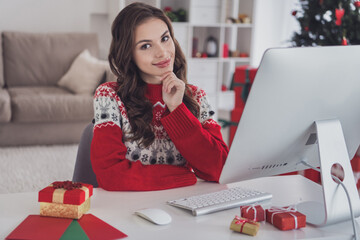 Photo of happy charming young woman sit computer table christmas holiday mood indoors inside house...