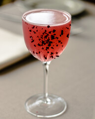 Red cocktail decorated with dried fruits at a restaurant