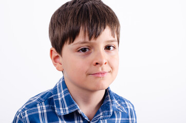 Cute boy in blue plaid shirt close up