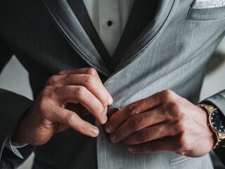 Man Buttoning Suit Jacket