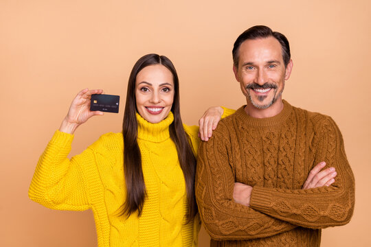 Photo of salers brunette couple crossed arms show card wear winter knitwear sweater isolated on beige color background