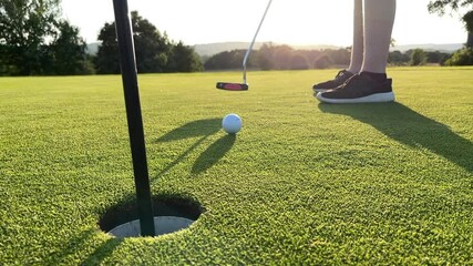 Young child missing a golf putt on a beautiful green