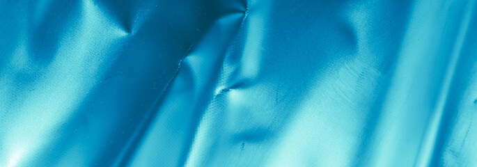 crinkled blue foil with visible details. background or texture