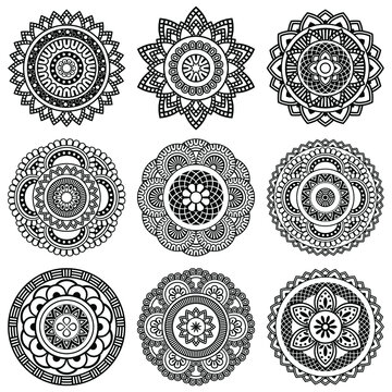 Isolated mandala in vector. Collection of round patterns in white and black colors. Vintage decorative elements. Set of abstract weaves for cards and coloring books