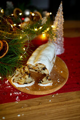 Fototapeta na wymiar Stollen German christmas bread, Christmas stollen on wooden background, Traditional festive pastry dessert.