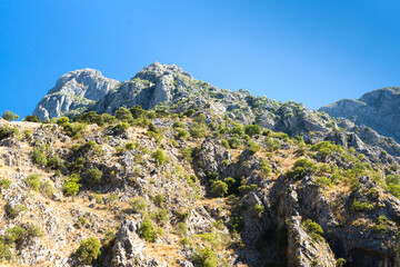 Beautiful landscape of rocky mountains and blue sky in sunny day. Hiking in the mountains. Travel in Montenegro.