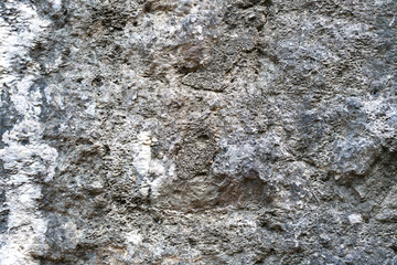 Texture of a old stone wall. Part of a wall in old town. Close-up.