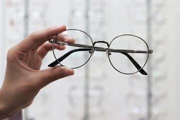 Round metal eyeglasses for vision. The concept of the optics salon