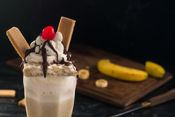 Yummy milkshake topped with cream and waffles
