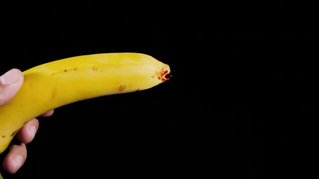 A ripe yellow banana with blood on its tip (visual representation of a sexual disease affecting the penis).
