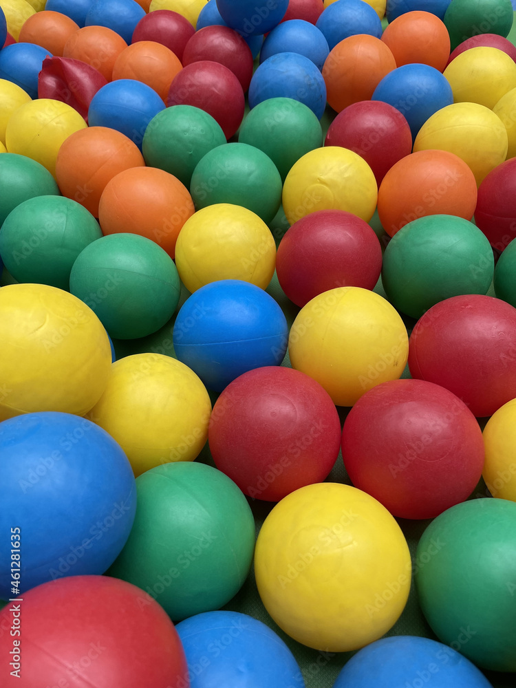 Wall mural Closeup shot of  colorful plastic balls in children's playground