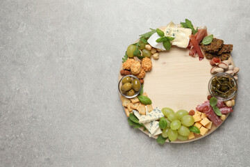 Different tasty appetizers on light table, top view. Space for text